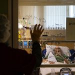 Heartbreaking photos show how frontline nurses treating COVID-19 patients live in the divide between home and the nightmare of the pandemic at work