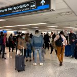 Millions fly over the weekend despite COVID-19 surge, travel warnings