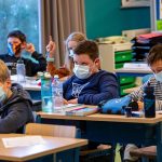 An unvaccinated teacher spread COVID-19 to 50% of students in a classroom after taking off a mask to read, CDC says
